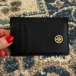 Navy blue Tory Burch credit card holder with silver hardware.